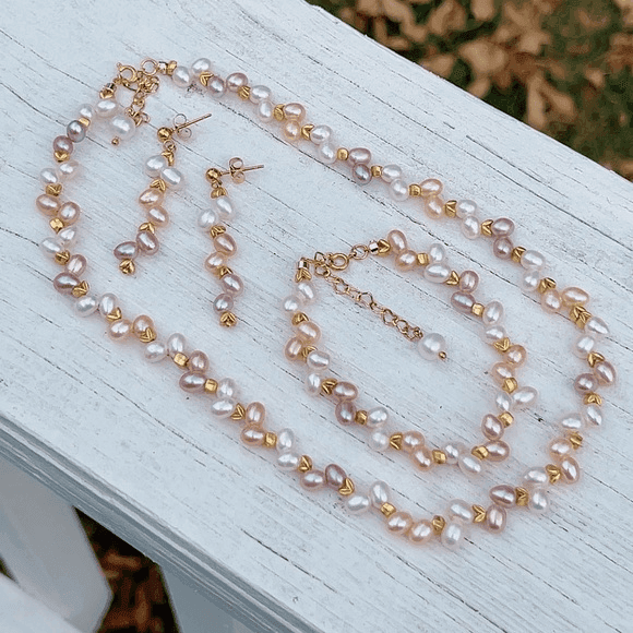 Gold accessories with watch and earrings on satin